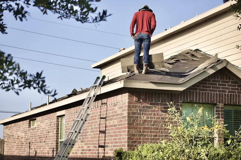 Professional roofer working on a residential roof in Skyline Park
